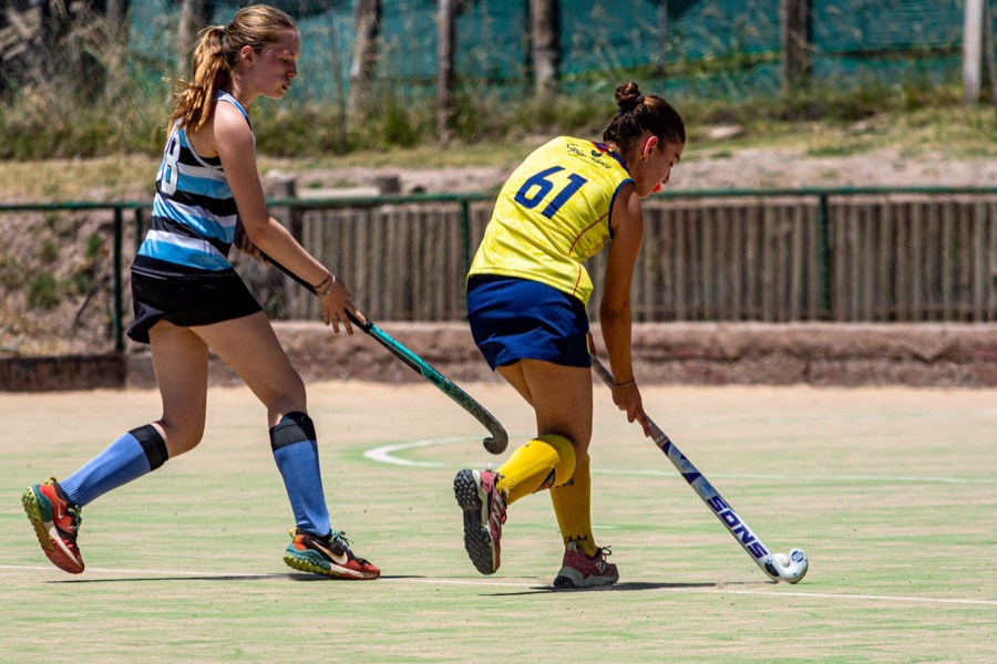 Schoolgirl hockey players contest the ball