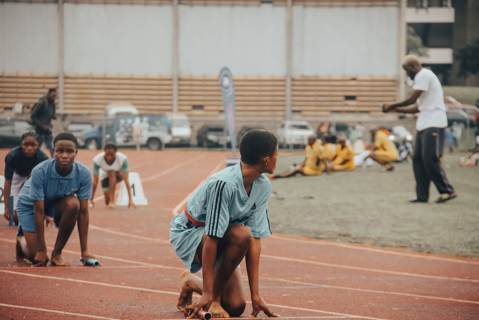 Children racing on a dusty school athletics track