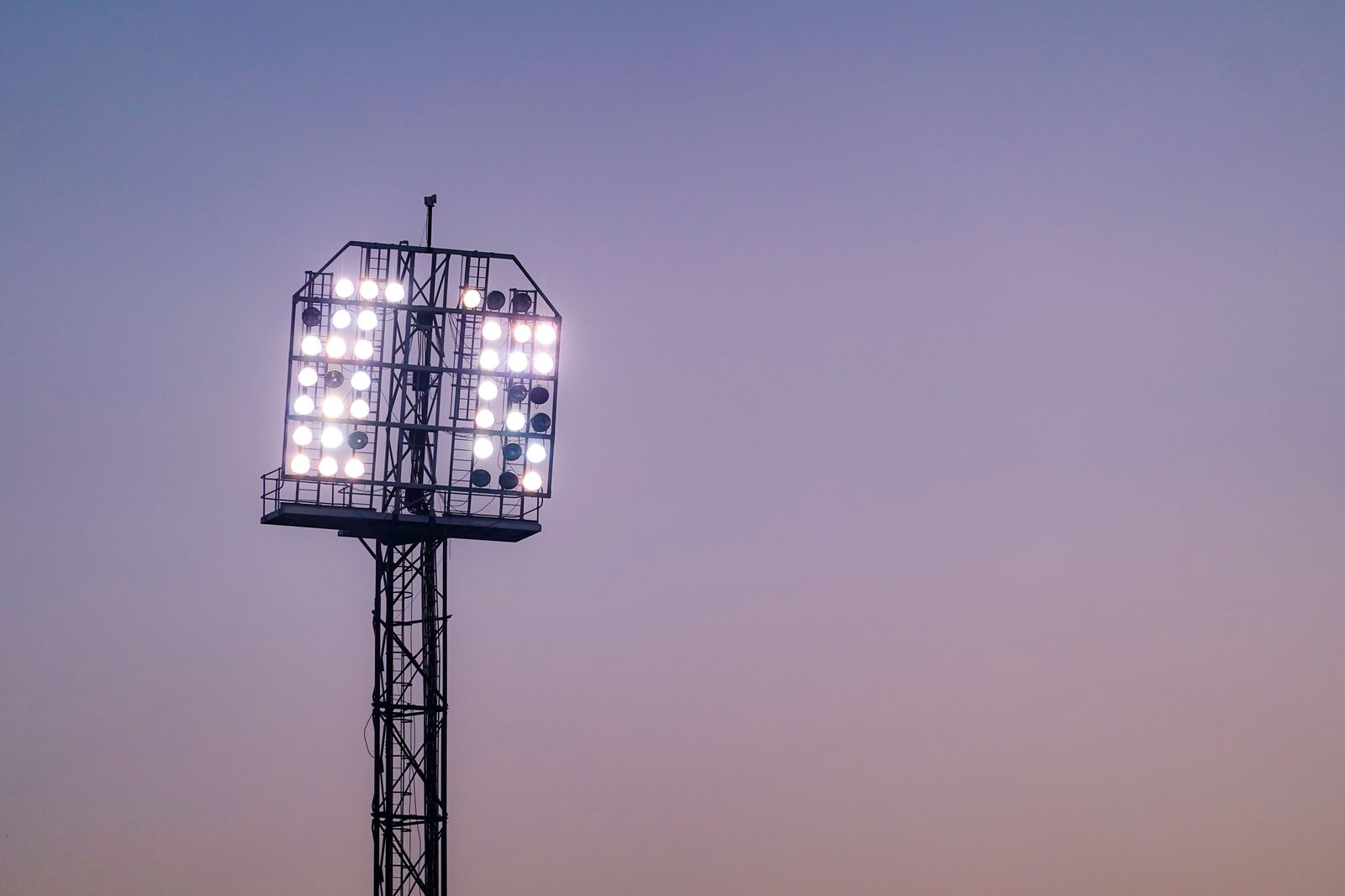 Stadium floodlight against a dusk sky