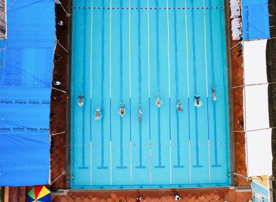 Swimmers racing in lanes seen from above